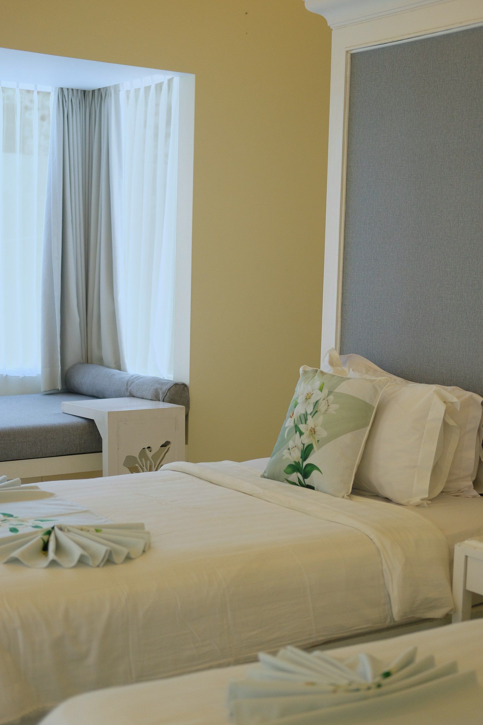 A villa bedroom with the yard and its private pool visible beyond.