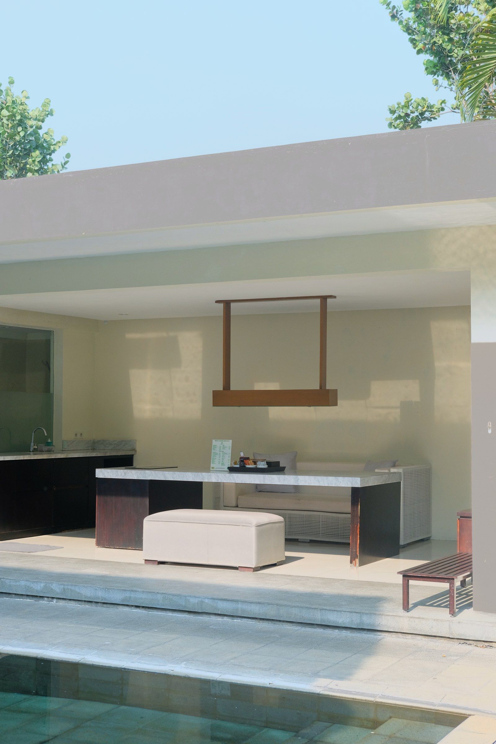 An open living space at the edge of the pool.